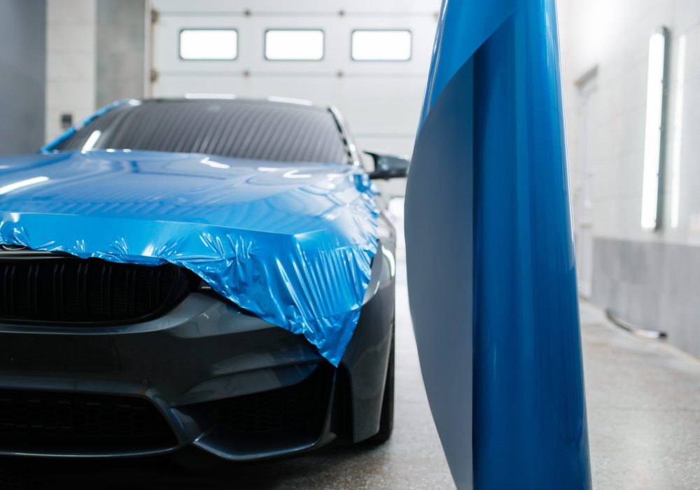 Car wrapping, protective vinyl foil or film installation on the vehicle, nobody. Auto detailing. Automobile paint protection, professional tuning