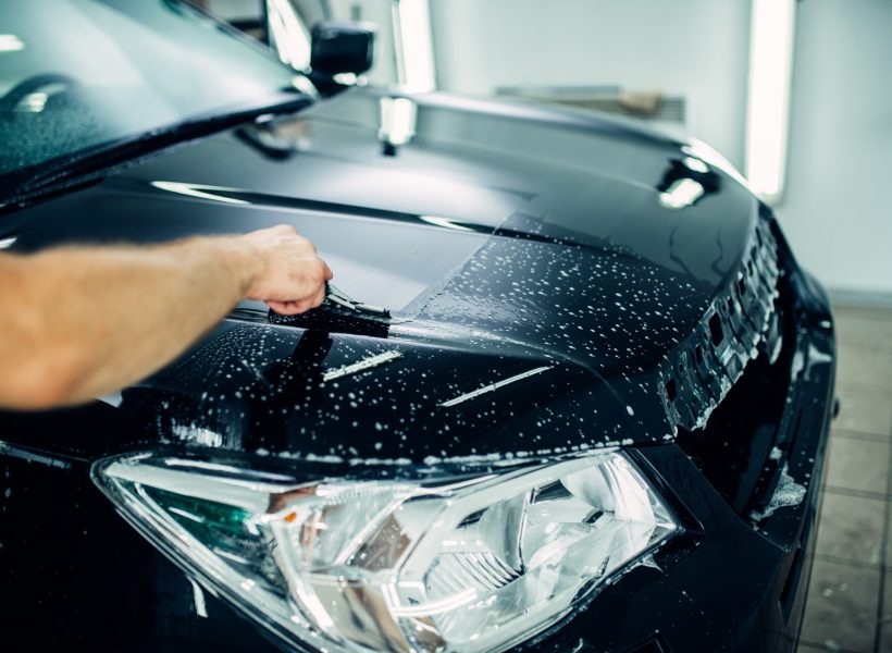 Specialist prepares car for protect against chips and scratches. Paint protection. Protective coating